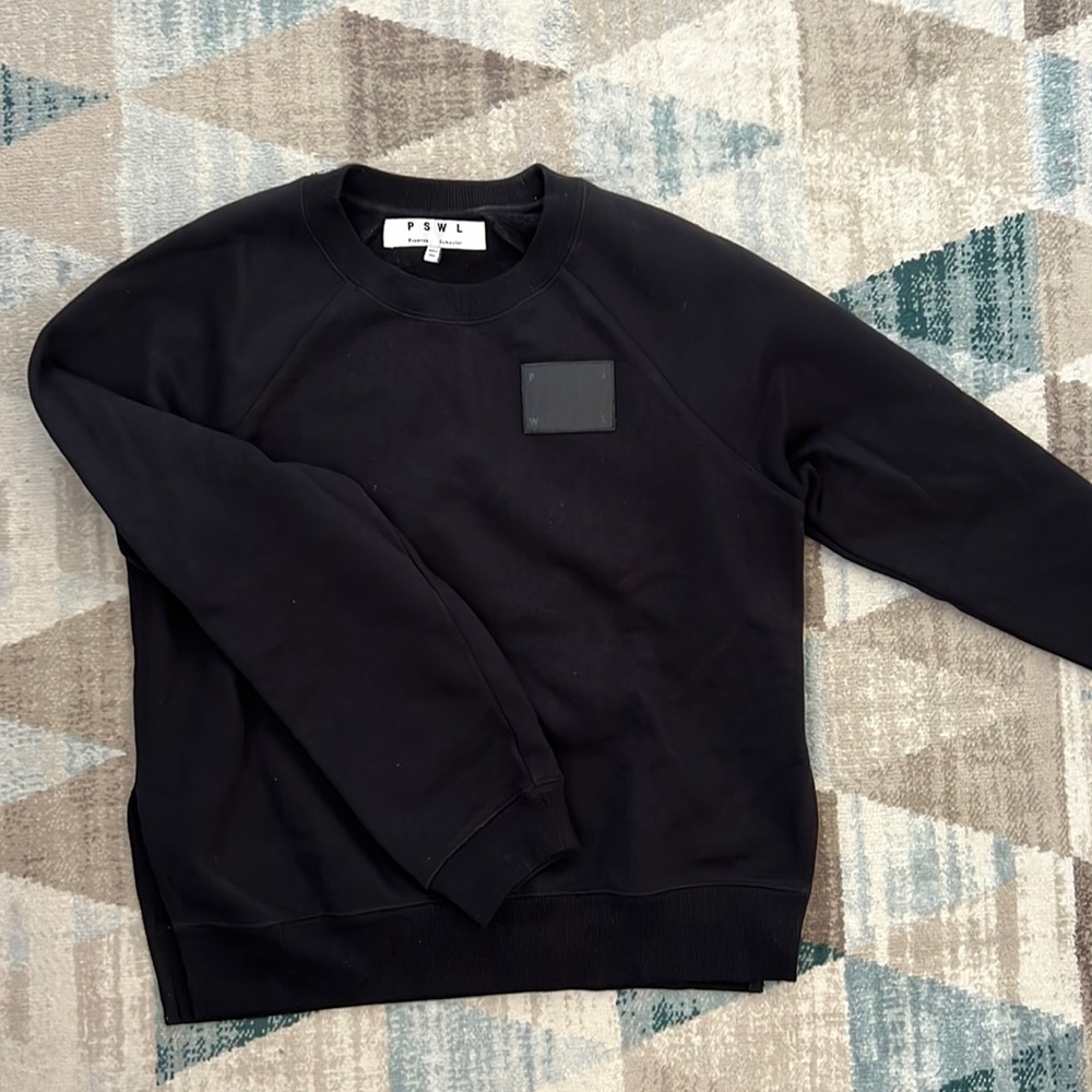 Proenza Schouler black hoodie with black leather chest detail.